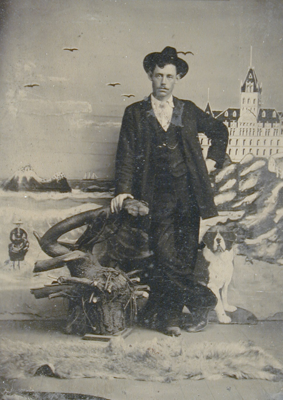 Studio Portrait in front of Cliff House [man in hat leaning on stump]