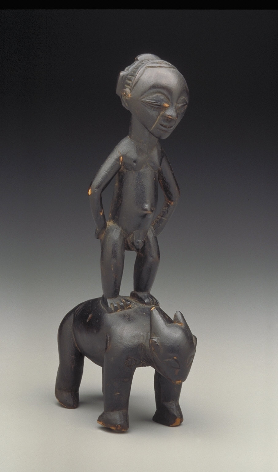 Male Figure Standing on Animal